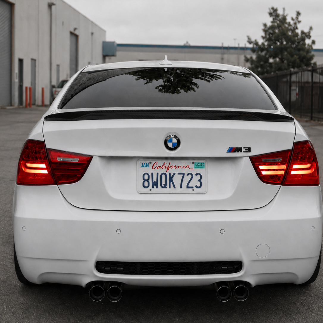 AlpineX Dynamics MP Style Carbon Fiber Rear Spoiler installed on a BMW E90 M3 featuring a glossy carbon fiber finish and a sleek rear-end aerodynamic enhancement.